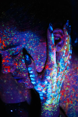 Model woman in neon light, beautiful model girl with fluorescent makeup, art design of disco dancer dancing in uv light, colorful makeup. nightclub, partyの写真素材