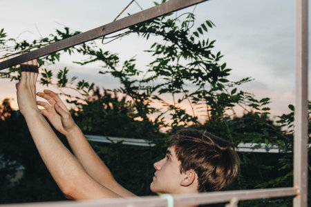 A teenager is caring for a young tree by gardening to save the world concept, nature, environment...