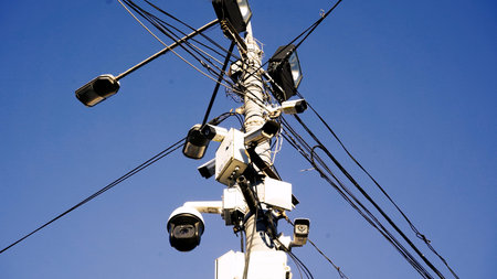 Security and alarm systems technology concept: Many CCTV cameras are hanging in the open space and...