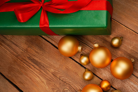 Top view photo of Christmas Flatlay gift box and Christmas tree decorations. Santa hat on a wooden background. Christmas background with place for text. Copyspace. Christmas tree toysの写真素材