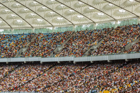 soccer inside stadium view. football field, empty stands, a crowd of fans, a roof against the sky.