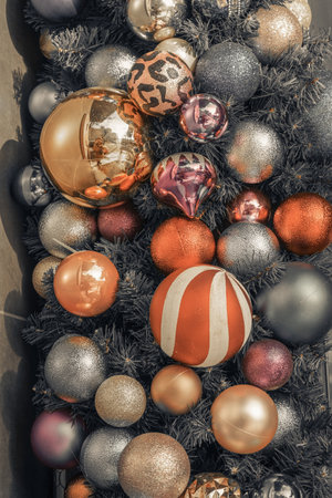 Decor for winter holidays. Christmas tree decoration. Home decoration in winter. Festive mood. New Year card. Christmas background. Red, white, blue and green decorations on a New Year tree branches.の写真素材