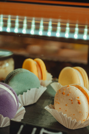French desert stacked by color and flavors, popular sweet meringue-based cookie with a light airy consistency and crunchy texture. Variety of macarons or macaroons displayed in a coffee shop window.の写真素材