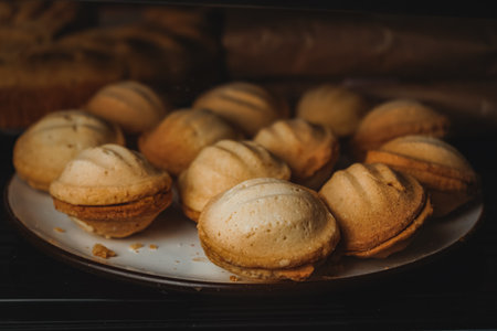 Modern bakery or patisserie. A display case of a bakery or coffeeshop. Various types of mini desserts in a display case. A dessert of nuts with condensed milk.の写真素材