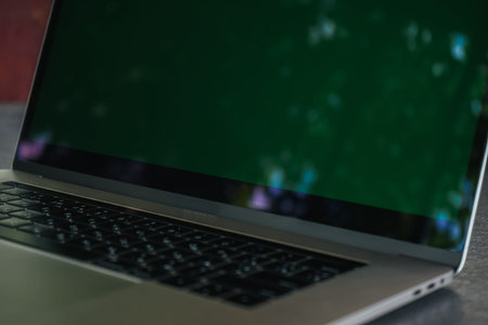 Laptop blank screen on grey table with nature background, mockup, template for your text. Clipping...