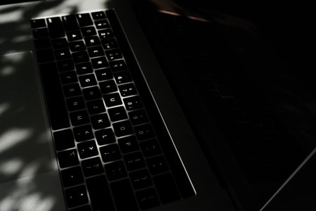Someone works on a laptop outdoors, hands closeup. Developing a project, investment and business, typing on the keyboard.の写真素材