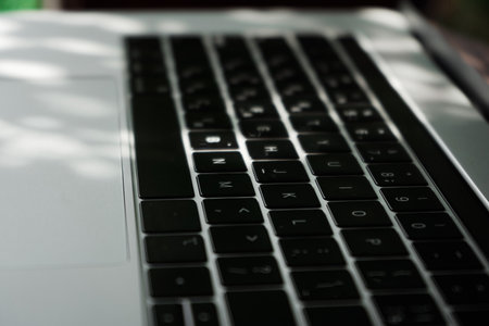 Silver designer laptop keyboard taken from above.の写真素材