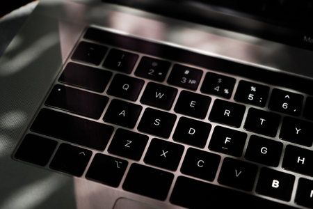 Someone works on a laptop outdoors, hands closeup. Developing a project, investment and business,...