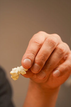 Junk food. Snack for cinema. Man holding popcorn to eat. Delicious snack to eat in the cinema. Salted popcorn. Popcorn. Fast food.の写真素材
