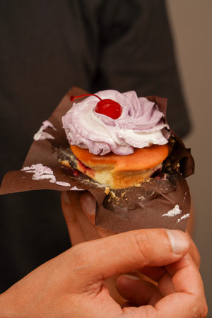 Tasty baking cupcakes, cake or muffin with pink cream icing, frosting. Bakery. Confectionery. Cupcake decoration. Cherry on top. Happy Birthday. Birthday cupcake with cherry on top. Cupcake.の写真素材