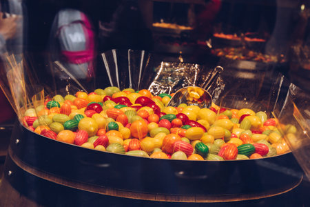 Prague, Czech Republic - May 11, 2019. A bunch of colorful dragees. Candies in multicolored glaze. Candy shop in Europe. Metal scoop inside. Basket full of colorful candies. Local sweet store.の写真素材