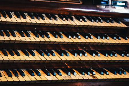 Vienna, Austria - May 12, 2019 Close up view of a church pipe organ with four keyboards. Piano keyboards in four raw. Professional music instrument.の写真素材