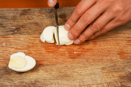 Preparing food. Horizontal photo. Board with boiled chicken eggs on table, closeup. Healthy food. Protein. Vegetarian.の写真素材