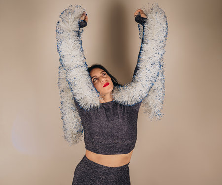 Young happy relaxed beautiful Caucasian brunette girl dancing. Having fun at the party, closes her eyes. Relaxation and fun concept.の写真素材