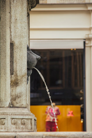 Vienna, Austria - May 12, 2019: Close up photo of side view of head of lion, Josephs Fountain on Green Street in the center of Vienna. A fountain in the shape of a lions head.の写真素材
