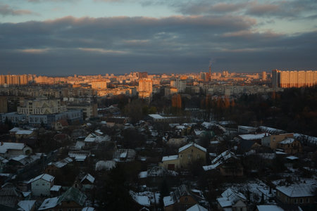Distant rooftops wear frosty caps, shimmering gently in daylight.の写真素材