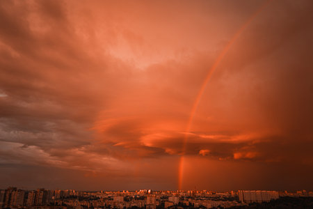 View of rainbow over buildings. Orange sky.の写真素材