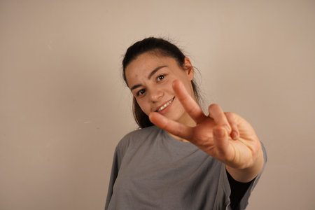 The movement captures the essence of loosening up and releasing tension. A simple act that signifies refreshment. The gesture reflects a sense of relaxation.の写真素材