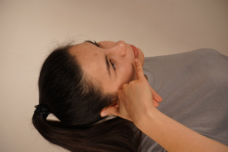 A hand raised to the ear mimics a phone call, suggesting connection or communication. This playful gesture embodies a call for attention or interaction. A universal symbol of staying in touch.の写真素材