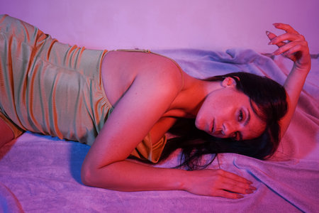 Girl lying on the floor, looking at the camera and dreaming about love.の写真素材