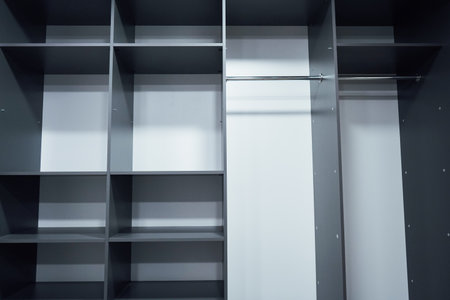 Spacious gray wardrobe with sliding doors, open to see storage dの写真素材