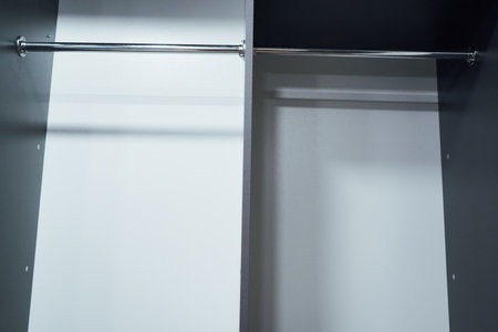 Open grey wardrobe with neatly stacked shelves. Minimalist desigの写真素材