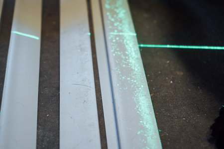 Two bright green laser beams appear one over the other on the floor, ensuring flawless accuracy in...