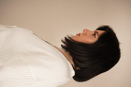 The composition emphasizes her elegant simplicity. A side profile of a young woman highlights her...