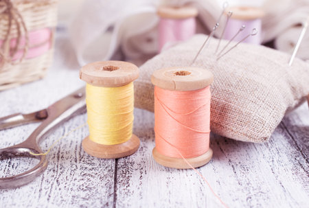 Set of reel of thread, scissors, needle and pins for sewing and needlework in the style Shabby Chic