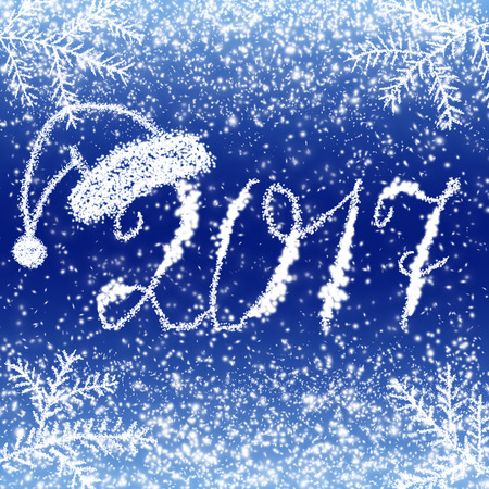 Christmas snow background with spruce, Santa Claus hat  and inscription 2017の写真素材