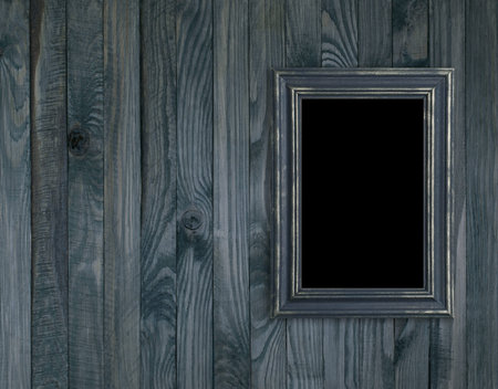 Vintage photo frame on wooden plank wall in retro styleの写真素材