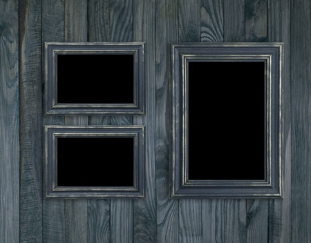 Vintage photo frames on wooden plank wall in retro style