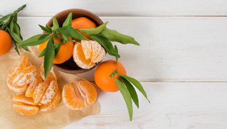Tropical still life with tangerines on wooden boardの写真素材