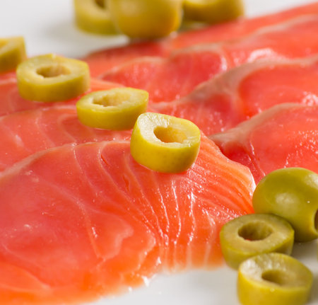 Sliced salted salmon served with oliveの写真素材