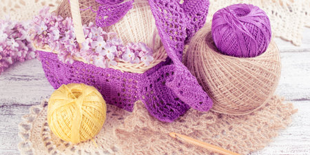 Yarn for crochet and knitted openwork napkins with lilac on shabby wooden boardsの写真素材