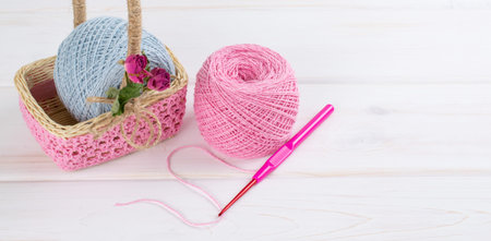 Yarn for crochet and  basket for handmade on white wooden boards in shabby chic styleの写真素材