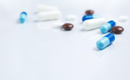 Medical theme. Pharmaceutical colorful pills and capsules on white background. Empty place for text.の写真素材