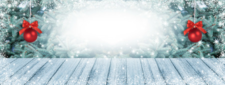 Christmas background with fir tree, two balls and snowfall. New Year winter holidays theme. Empty space for your decoration, text or advertising.の写真素材