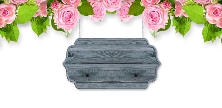 Floral garland with roses isolated on white background with wooden signboard and place for your photo or text.の写真素材