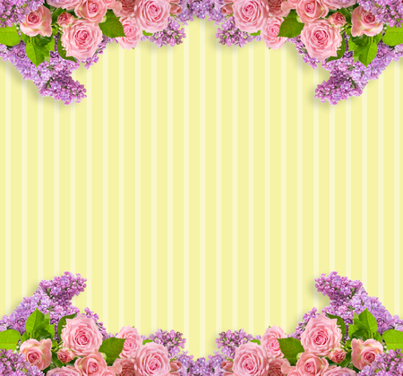 Pink roses and lilacs frame on striped yellow background with place for your photo or textの写真素材