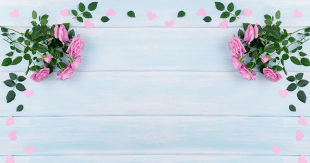 Top view of pink roses with paper hearts on background of shabby wooden planks and place for your textの写真素材