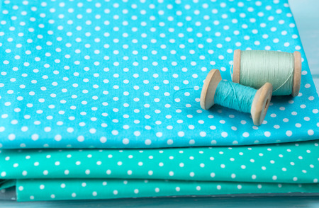 Workplace for seamstress with set of reel of thread and fabric for sewing and needleworkの写真素材