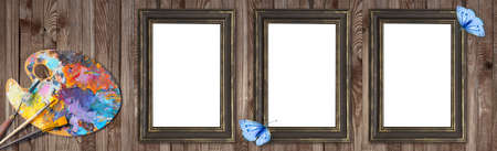 Palette for oil paints with brushes, palette knife and picture frames with butterfly on shabby wooden background for design shop artists. Template for oil art master class advertising.の写真素材