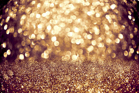 Shining glowing background with shiny sparkling bokeh and magic golden glitterの写真素材