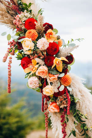 Wedding arch in Boho style. Floral arrangements of autumn flowersの写真素材