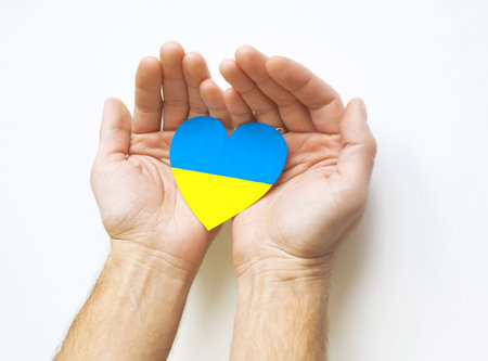 Love Ukraine concept. Hands in the shape of a heart are painted in the color of the flag of Ukraine - yellow and blue. selective focus. Independence Day of Ukraine, flagの写真素材