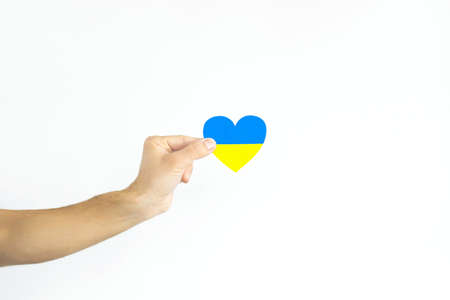 Love Ukraine concept. Hands in the shape of a heart are painted in the color of the flag of Ukraine - yellow and blue. selective focus. Independence Day of Ukraine, flagの写真素材