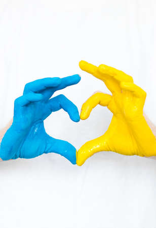 Love Ukraine concept. Hands in the shape of a heart are painted in the color of the flag of Ukraine - yellow and blue. selective focus. Independence Day of Ukraine, flagの写真素材