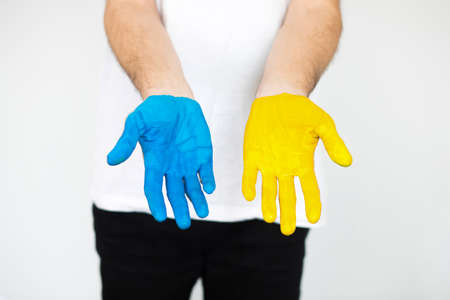 Love Ukraine concept. Hands in the shape of a heart are painted in the color of the flag of Ukraine - yellow and blue. selective focus. Independence Day of Ukraine, flagの写真素材