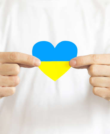 Love Ukraine concept. Hands in the shape of a heart are painted in the color of the flag of Ukraine - yellow and blue. selective focus. Independence Day of Ukraine, flagの写真素材